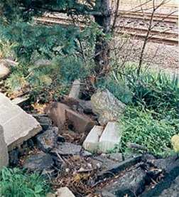 Busy railroad tracks next to an existing cemetery... poorly kept areas and in a state of disrepair.