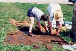 A gross misuse of of old cemetery gravestones... Here, they were used as "pavers" to create a driveway in the cemetery! In photo at the left, volunteers are taking them up to be put back in their rightful place.